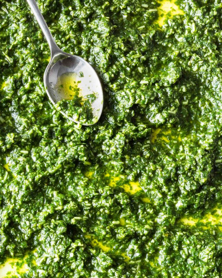 Close up of fresh basil pesto with spoon