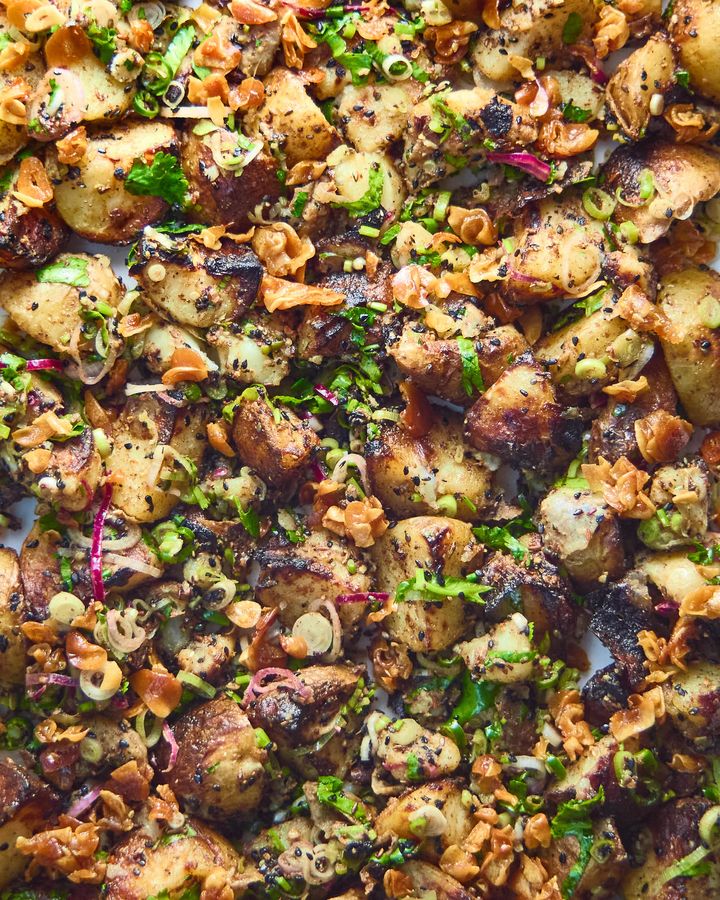 Close up of smoky roasted potatoes with Indian-style seasonings and crispy garlic