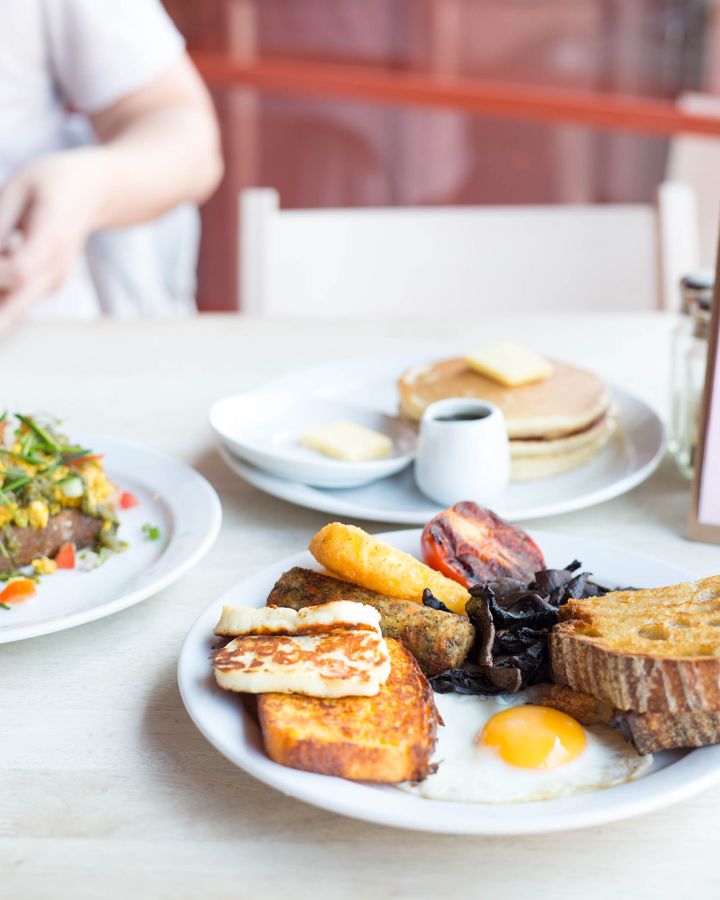 Vegetarian full English breakfast on a café table with pancakes